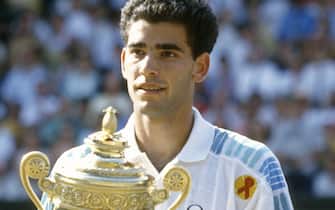 LONDON - CIRCA 1993:  Pete Sampras of United States holds the trophy after defeating Jim Courier 7"u20136(7"u20133), 7"u20136(8"u20136), 3"u20136, 6"u20133 in the championship match at the Wimbledon Lawn Tennis Championships circa 1993 at the All England Lawn Tennis and Croquet Club in London, England. (Photo by Focus on Sport/Getty Images)
