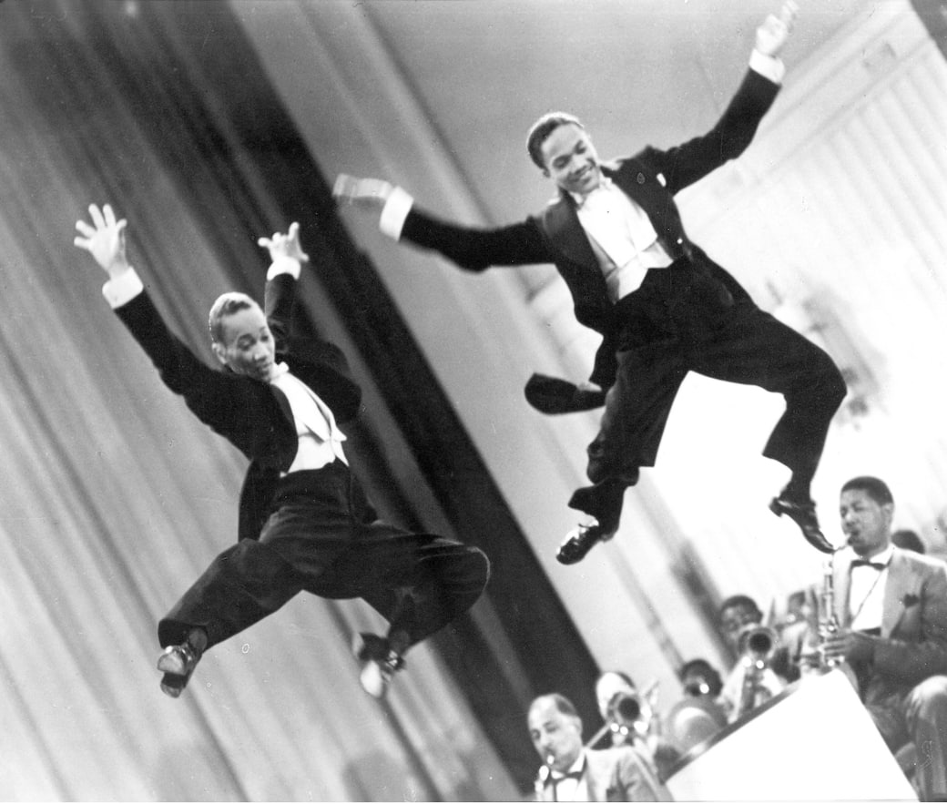 The_Nicholas_Brothers_in_a_scene_from_Stormy_Weather_(1943)_Fayard_Nicholas_left_and_Harold_Nicholas_in_Stormy_Weather_(1950)._Courtesy_Margaret_Herrick_Library_©_Twentieth_Cent.jpeg