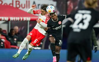 13 January 2024, Saxony, Leipzig: Soccer, Bundesliga, Matchday 17, RB Leipzig - Eintracht Frankfurt, Red Bull Arena: Leipzig's new signing Eljif Elmas (l) and Frankfurt's Aurelio Buta in a header duel. Photo: Jan Woitas/dpa - IMPORTANT NOTE: In accordance with the regulations of the DFL German Football League and the DFB German Football Association, it is prohibited to utilize or have utilized photographs taken in the stadium and/or of the match in the form of sequential images and/or video-like photo series.
