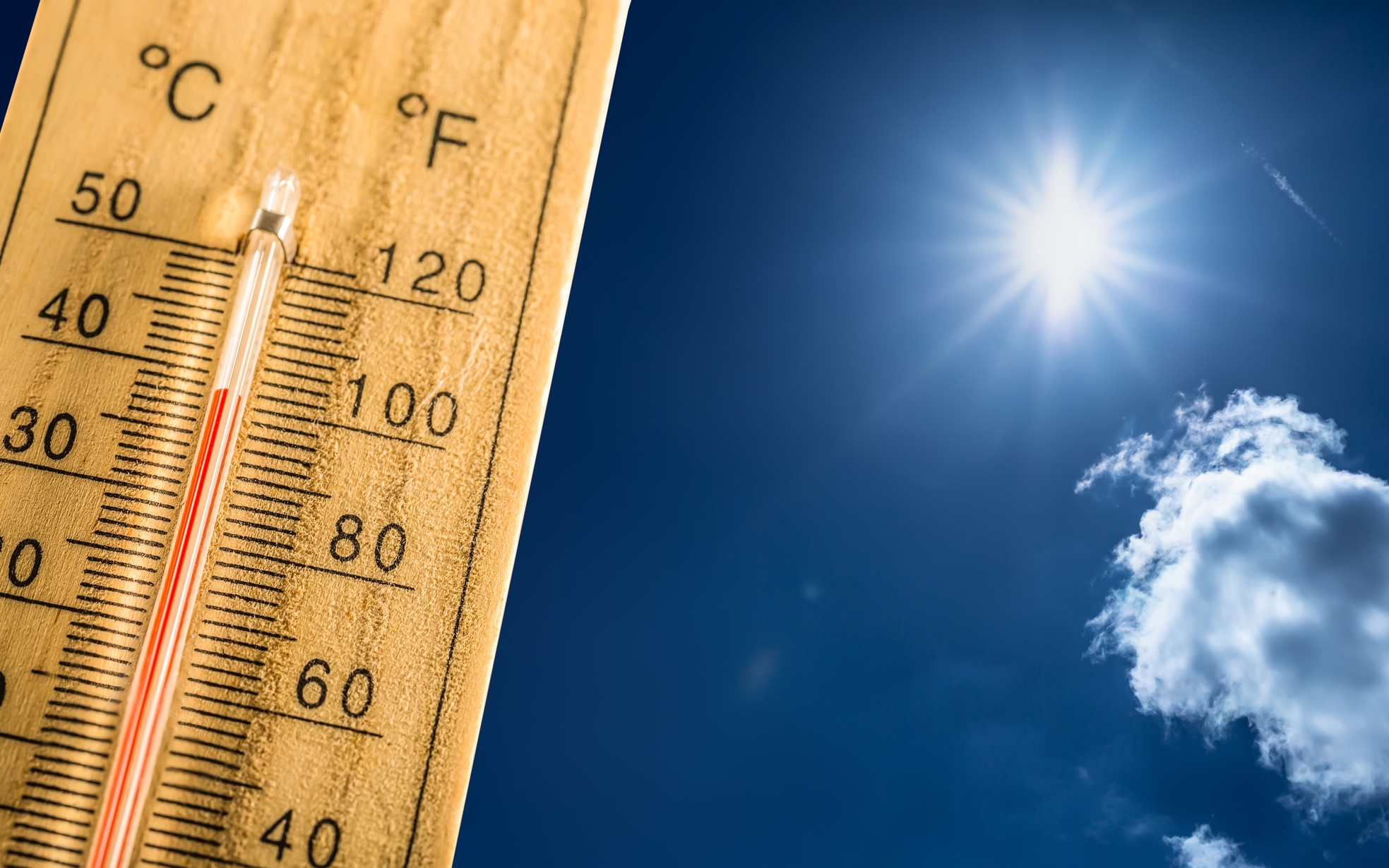 Hot summer day and forty degrees Celsius on a thermometer. Thermometer in summer day shows high temperature degree with sun in background.