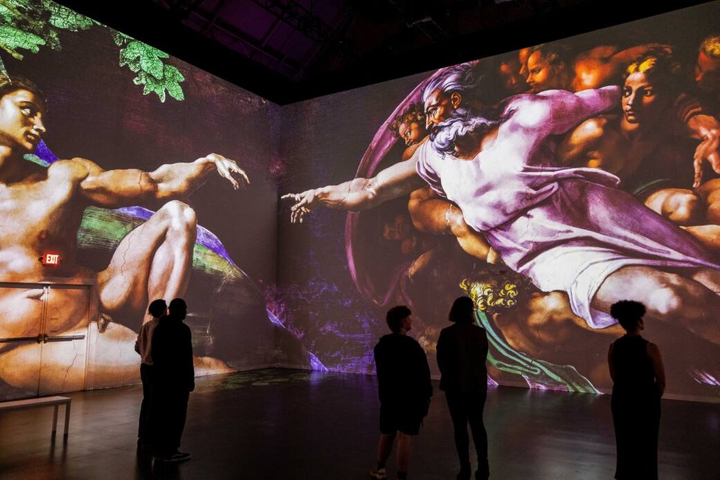 Viewers_take_in_“The_Creation_of_Adam”_by_Michelangelo_featured_in_“Immersive_Vatican.”_Photo_credit_Patrick_Hodgson.jpg