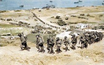 American troops land on a beach. They will serve as reinforcements for the troops at the Normandy front. THE EXTRAORDINARY BRAVERY of the men who took part in D-Day has been highlighted in a series of stunning colourised images to commemorate the 74th anniversary. Striking shots show American and British troops arriving on French beaches for the invasions, D-Day Invasion glider pilots on landing craft and British Airborne Pathfinders at Harwell checking their watches on night of 5th June 1944. Other vivid colour pictures show Nazi General Erwin Rommel inspecting their defences, a German Panzer VI Tiger I Tank camouflaged in the undergrowth in Villers-Bocage, Normandy and men of the British 22nd Independent Parachute Company, 6th Airborne Division being briefed for the invasion. The original black and white photographs were painstakingly colourised by electrician Royston Leonard (55), from Cardiff, Wales, with each snap taking between four and five hours to complete. Royston Leonard / mediadrumworld.com