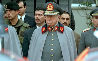 E63-19980309-SANTIAGO-POL: CILE: PINOCHET, L'ULTIMO GIORNO DA GENERALE. (FILES) This 11 September 1997 file photo shows Chilean former dictator and current army commander Gen. Augusto Pinochet (C) at the commemoration of the 24th anniversary of the bloody military coup he led against leftist president Salvador Allende. Pinochet, accused of genocide and human rights violations during his 17-year dictatorship, is expected to retire 11 March 1998 to take a lifetime senate seat as a former president under the terms of his own amendments to the Chilean constitution.   ANSA/TO