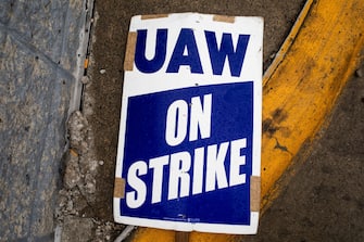 A "UAW On Strike" sign near a picket line outside the Ford Motor Co. Michigan Assembly plant in Wayne, Michigan, US, on Tuesday, Sept. 26, 2023. PresidentÂ Joe BidenÂ endorsed theÂ United Auto Workers' demand for a major wage increase during a visit to a picket line at aÂ General Motors Co.Â plant in suburban Detroit, a historic show of solidarity with organized labor. Photographer: Emily Elconin/Bloomberg via Getty Images