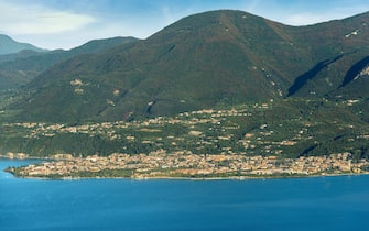 Aerial view of the two small towns of Toscolano and Maderno on the Garda Lake coast. Lombardia, Brescia, Italy, Europe