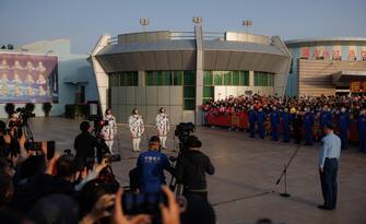 epa10662668 (L-R) Payload expert Gui Haichao, commander Jing Haipeng, and space flight engineer Zhu Yangzhu attend a seeing-off ceremony before boarding for the launch of the Long March-2F carrier rocket with a Shenzhou-16 manned space flight at the Jiuquan Satellite Launch Centre, in Jiuquan, Gansu province, China, 30 May 2023. The Shenzhou-16 manned space flight mission will transport three Chinese astronauts to the Tiangong space station.  EPA/ALEX PLAVEVSKI