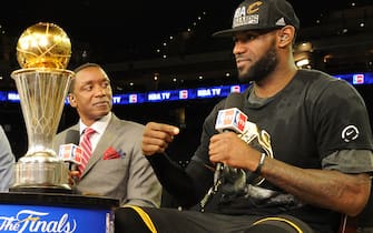 OAKLAND, CA - JUNE 19:  Matt Winer, Steve Smith, Grant Hill and Isiah Thomas interview LeBron James #23 of the Cleveland Cavaliers while he celebrates with the Larry O'Brien NBA Championship Trophy after winning Game Seven of the 2016 NBA Finals against the Golden State Warriors on June 19, 2016 at ORACLE Arena in Oakland, California. NOTE TO USER: User expressly acknowledges and agrees that, by downloading and/or using this Photograph, user is consenting to the terms and conditions of the Getty Images License Agreement. Mandatory Copyright Notice: Copyright 2016 NBAE (Photo by Andrew D. Bernstein/NBAE via Getty Images)