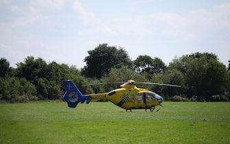 epa11505864 An air ambulance at the scene of suspected multiple stabbings at Meols Cop High School in Southport, Britain, 29 July 2024. Armed police detained a male and seized a knife after a number of people were injured in a reported stabbing according to Merseyside Police. Eight patients with stab injuries have been treated at the scene so far and have been taken to hospitals, North West Ambulance Service said.  EPA/ADAM VAUGHAN