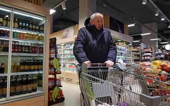 epa10298057 A man shops at a Miratorg supermarket in Moscow, Russia, 10 November 2022. Miratorg one of the leading agribusiness holdings and food retailers in Russia.  EPA/MAXIM SHIPENKOV