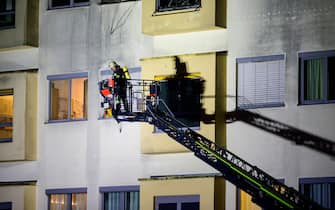 05 January 2024, Lower Saxony, Uelzen: A volunteer firefighter works on the fire at the hospital using a turntable ladder. The fire broke out on the third floor of the hospital late on Thursday evening. One person died and 22 others were injured, six of them seriously. Photo: Philipp Schulze/dpa (Photo by Philipp Schulze/picture alliance via Getty Images)