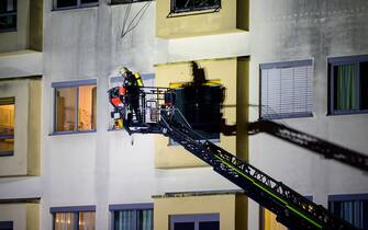 05 January 2024, Lower Saxony, Uelzen: A volunteer firefighter works on the fire at the hospital using a turntable ladder. The fire broke out on the third floor of the hospital late on Thursday evening. One person died and 22 others were injured, six of them seriously. Photo: Philipp Schulze/dpa (Photo by Philipp Schulze/picture alliance via Getty Images)