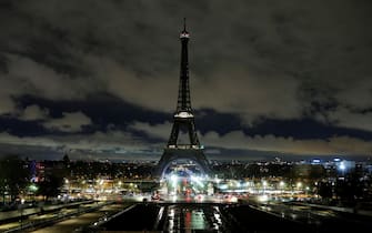 This photograph shows the Eiffel Tower switched off for an hour in Paris on March 22, 2025, as part of the international campaign Earth Hour launched by the NGO WWF. (Photo by GEOFFROY VAN DER HASSELT / AFP)