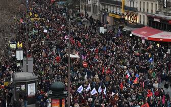 TOPSHOT - Protesters march during a rally on a second day of nationwide strikes and protests over the government's proposed pension reform, in Paris on January 31, 2023. - France braces for major transport blockages, with mass strikes and protests set to hit the country for the second time in a month in objection to the planned boost of the age of retirement from 62 to 64. On January 19, some 1.1 million voiced their opposition to the proposed shake-up -- the largest protests since the last major round of pension reform in 2010. (Photo by Alain JOCARD / AFP) (Photo by ALAIN JOCARD/AFP via Getty Images)