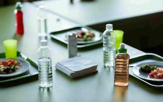 Food with water bottles on table