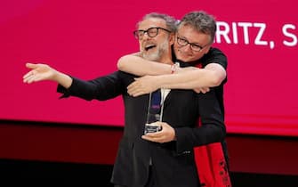epa10702672 Spanish chef Andoni Luis Audirz (R) jokes with Italian chef Massimo Bottura as he receives the Icon Award during the World's 50 Best Restaurants gala in Valencia, Spain, 20 June 2023. The gala awards the 50 best restaurants and chefs of the world.  EPA/Manuel Bruque