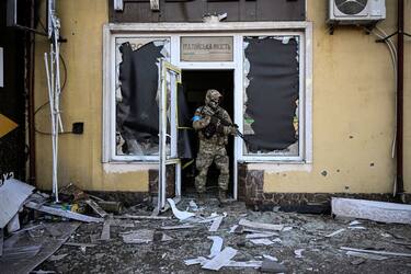 TOPSHOT - A Ukrainian serviceman exits a damaged building after shelling in Kyiv, on March 12, 2022. - Russian forces are positioned around Kiev on March 12, 2022 and are "blocking" Mariupol, where thousands of people are suffering a devastating siege, in southern Ukraine, a country that has been bombed for more than two weeks. (Photo by Aris Messinis / AFP) / The erroneous mention[s] appearing in the metadata of this photo by Aris Messinis has been modified in AFP systems in the following manner: [on March 12, 2022] instead of  [March 11, 2022]. Please immediately remove the erroneous mention  from all your online services and delete it (them) from your servers. If you have been authorized by AFP to distribute it (them) to third parties, please ensure that the same actions are carried out by them. Failure to promptly comply with these instructions will entail liability on your part for any continued or post notification usage. Therefore we thank you very much for all your attention and prompt action. We are sorry for the inconvenience this notification may cause and remain at your disposal for any further information you may require. (Photo by ARIS MESSINIS/AFP via Getty Images)
