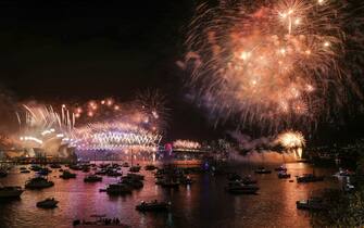 SYDNEY, AUSTRALIA - JANUARY 01: Fireworks light up the sky over Sydney Harbour Bridge during New Year's Eve celebration on January 01, 2023 in Sydney, Australia. Revelers turned out in droves to celebrate the arrival of the new year, the first since pandemic restrictions were completely removed in early 2022. (Photo by Roni Bintang/Getty Images)