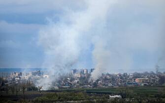 (FILES) Smoke billows from the town of Bakhmut, Donetsk region, on April 22, 2023, amid the Russian invasion on Ukraine. Russia's private army Wagner claimed on May 20, 2023, the total control of the east Ukrainian city of Bakhmut, the epicentre of fighting, as Kyiv said the battle was continuing but admitted the situation was "critical". Bakhmut, a salt mining town that once had a population of 70,000 people, has been the scene of the longest and bloodiest battle in Moscow's more than year-long Ukraine offensive. The fall to Russia of Bakhmut, where both Moscow and Kyiv are believed to have suffered huge losses, would have high symbolic value. (Photo by Anatolii STEPANOV / AFP)