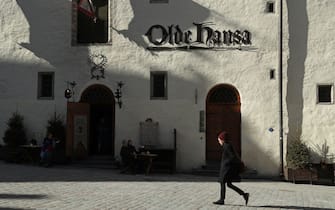 TALLINN, ESTONIA - MARCH 24:  A man walks past the Olde Hansa restaurant in the historic city center on March 24, 2017 in Tallinn, Estonia. Tallinn's old town escaped destruction during Wold War II and today is a UNESCO World Heritage Site.  (Photo by Sean Gallup/Getty Images)
