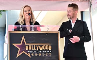 US actor Macaulay Culkin looks on as Canadian-US actress Catherine O'Hara speaks during his Hollywood Walk of Fame Star ceremony in Hollywood, California, on December 1, 2023. (Photo by Frederic J. BROWN / AFP)