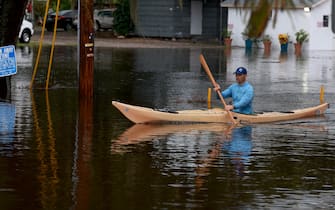 TARPON SPRINGS, FLORIDA - AUGUST 30: A person rides a kayak through the flooded streets caused by Hurricane Idalia passing offshore on August 30, 2023 in Tarpon Springs, Florida. Hurricane Idalia is hitting the Big Bend area of Florida.  (Photo by Joe Raedle/Getty Images)