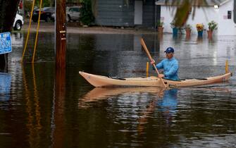 TARPON SPRINGS, FLORIDA - AUGUST 30: A person rides a kayak through the flooded streets caused by Hurricane Idalia passing offshore on August 30, 2023 in Tarpon Springs, Florida. Hurricane Idalia is hitting the Big Bend area of Florida.  (Photo by Joe Raedle/Getty Images)
