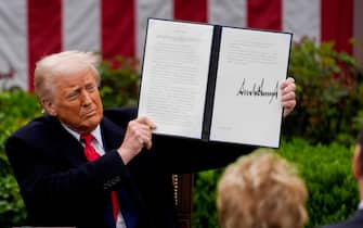 epa12006231 US President Donald Trump US President Donald Trump holds up a signed executive order during a tariff announcement in the Rose Garden of the White House in Washington, DC, USA, 02 April 2025. Trump plans to roll out tariffs on global trading partners, the centerpiece of his effort to bring back manufacturing to the US and reshape a world trade system he has long decried as unfair. Trump has branded the day 'Liberation Day', though most economists expect US consumers to foot the costs.  EPA/KENT NISHIMURA / POOL