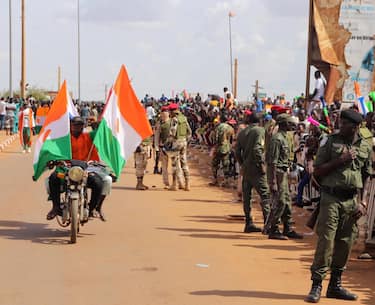 epa10824346 Security forces stand guard as supporters of the military junta gather at a roundabout leading to the French airbase during a rally in Niamey, Niger, 27 August 2023. The junta gave the French ambassador to Niger 48 hours to leave the country.  EPA/ISSIFOU DJIBO