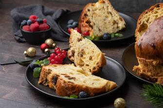 Traditional Italian Christmas cake panettone with raisins and candied fruits, fruit bread. Holiday food for Christmas and New Year