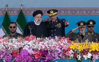 Commander of Iran's Army Air Force, Brigadier General Hamid Vahedi (3rd R) salutes while speaking with Iranian President Ebrahim Raisi (2nd L) during a military parade marking Iran's Army Day anniversary near the Imam Khomeini shrine in the south of Tehran, April 18, 2023. Raisi said, we will destroy Haifa and Tel Aviv if Israel takes ''the slightest action'' against Iran.  (Photo by Morteza Nikoubazl/NurPhoto via Getty Images)