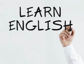 Businessman writing "learn english"