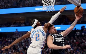 DALLAS, TEXAS - MAY 13: Luka Doncic #77 of the Dallas Mavericks drives to the basket against Shai Gilgeous-Alexander #2 of the Oklahoma City Thunder during the first quarter in Game Four of the Western Conference Second Round Playoffs at American Airlines Center on May 13, 2024 in Dallas, Texas. NOTE TO USER: User expressly acknowledges and agrees that, by downloading and or using this photograph, User is consenting to the terms and conditions of the Getty Images License Agreement. (Photo by Tim Heitman/Getty Images)