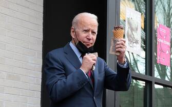 January 25, 2022, Washington, District of Columbia, USA: United States President JOE BIDEN waves with an ice cream cone in his hand as he walks out of Jeni's Ice Creams in Washington, DC. Biden visited local small businesses to highlight the tremendous growth in new small business applications since the start of the Biden-Harris administration. (Credit Image: Â© Oliver Contreras/CNP via ZUMA Press Wire)