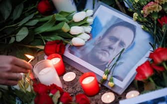 epaselect epa11159716 A person lights a candle next to flowers and and a portrait of Russian opposition leader Alexei Navalny in front of the Russian embassy, in Berlin, Germany, 16 February 2024. Russian opposition leader and outspoken Kremlin critic Alexei Navalny has died aged 47 in a penal colony, the Federal Penitentiary Service of the Yamalo-Nenets Autonomous District announced on 16 February 2024. A prison service statement said that Navalny 'felt unwell' after a walk on 16 February, and it was investigating the causes of his death. In late 2023 Navalny was transferred to an Arctic penal colony considered one of the harshest prisons.  EPA/CLEMENS BILAN