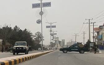 Taliban security personnel (R) block a road in Mazar-i-Sharif on March 9, 2023, following a blast at the office of Taliban governor of Afghanistan's Balkh province. - Mohammad Dawood Muzammil, the Taliban governor of Afghanistan's Balkh province, was killed in a blast at his office on March 9, the province's police spokesman said. (Photo by Atif ARYAN / AFP) (Photo by ATIF ARYAN/AFP via Getty Images)