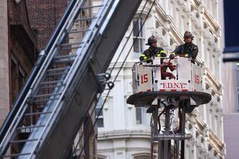 epaselect epa10579266 New York City Fire Department firefighters work on ladder trucks at the scene of a parking structure collapse in the Financial District of New York City, New York, USA, 18 April 2023. Fire Department officials have reported three injuries but advised they expect that to increase.  EPA/JUSTIN LANE