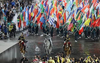 Floriane Issert, a Gendarmerie non-commissioned officer of the National Gendarmerie, carries the Olympic flag as she rides on the Iena bridge during the opening ceremony of the Paris 2024 Olympic Games in Paris on July 26, 2024. (Photo by Ludovic MARIN / POOL / AFP) (Photo by LUDOVIC MARIN/POOL/AFP via Getty Images)