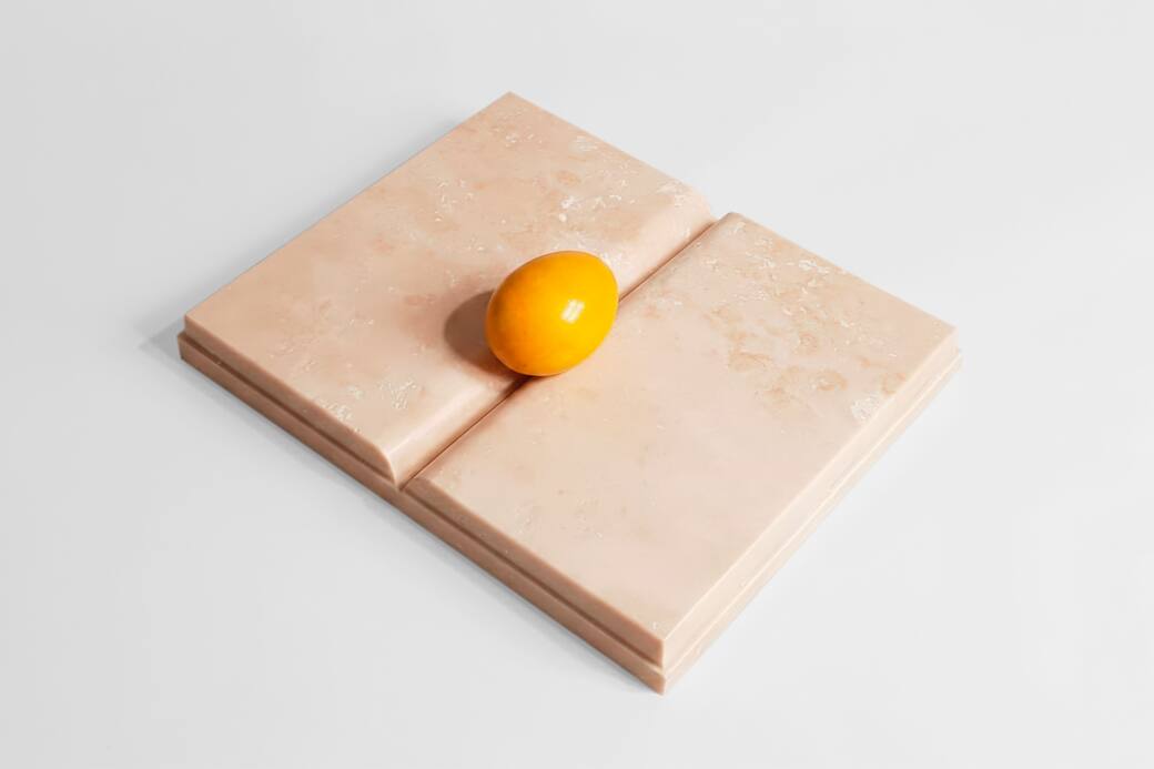 Mirella Bentivoglio, Libro Uovo Giallo, 2000, travertino e marmo giallo, 21 × 26 × 3 cm