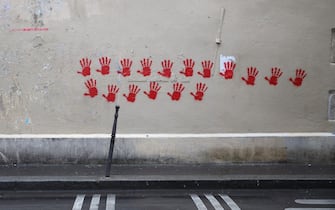 A picture shows red hand graffitis painted on a building wall of the Moussy street, in the area where earlier the Holocaust memorial was vandalized with the same red hand prints in Paris, on May 14, 2024. A French Jewish organisation on May 14 condemned a "hateful rallying cry against Jews" and Paris authorities filed a criminal complaint after red hand graffiti was painted onto France's Holocaust Memorial. (Photo by Antonin UTZ / AFP) (Photo by ANTONIN UTZ/AFP via Getty Images)