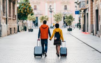 Young couple with suitcases just arriving in Valencia