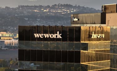SAN MATEO, CALIFORNIA - NOVEMBER 01: In an aerial view, a sign is posted on the exterior of a WeWork office on November 01, 2023 in San Mateo, California. Shares of WeWork dropped over 35 percent in Wednesday morning trading following news reports that the New York-based company is planning to file for Chapter 11 bankruptcy. (Photo by Justin Sullivan/Getty Images)
