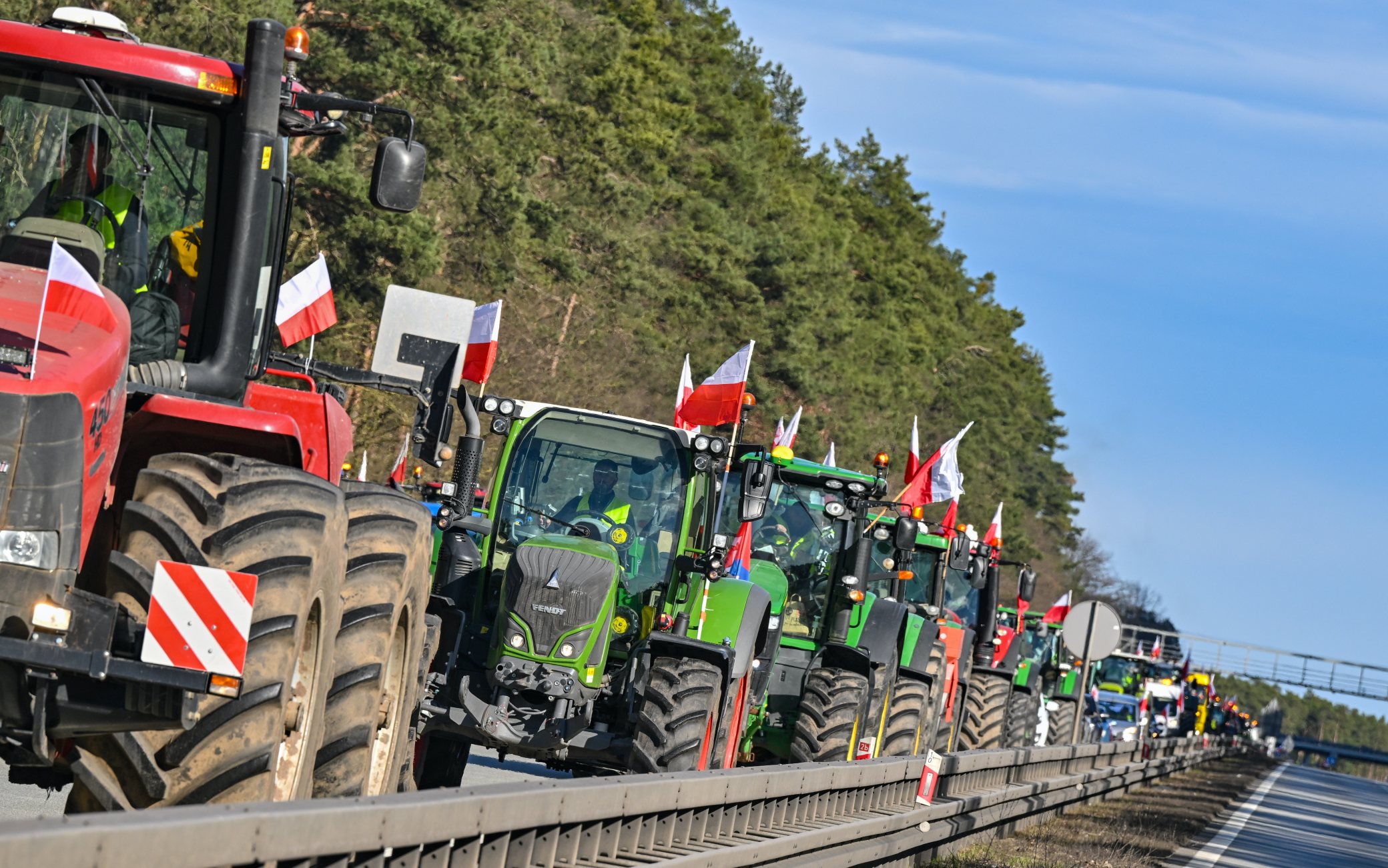 25 February 2024, Poland, Slubice: Farmers from Poland are driving their vehicles on the A2 autostrada (European route 30) towards the German-Polish border (Frankfurt/Oder). The protests by Polish farmers, which have been going on for weeks, are directed against the EU agricultural policy, but also against the import of cheap agricultural products from Ukraine. Photo: Patrick Pleul/dpa (Photo by Patrick Pleul/picture alliance via Getty Images)