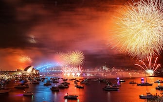 SYDNEY, AUSTRALIA - JANUARY 01: Fireworks light up the sky over Sydney Harbour Bridge during New Year's Eve celebration on January 01, 2023 in Sydney, Australia. Revelers turned out in droves to celebrate the arrival of the new year, the first since pandemic restrictions were completely removed in early 2022. (Photo by Roni Bintang/Getty Images)