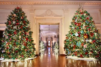 Christmas trees are seen in the East Room looking towards the Cross Hall during the media preview for the 2023 Holidays at the White House in Washington, DC on November 27, 2023. The theme for the 2023 White House holiday decorations is The "Magic, Wonder, and Joy" of the Holidays. (Photo by Mandel NGAN / AFP) (Photo by MANDEL NGAN/AFP via Getty Images)