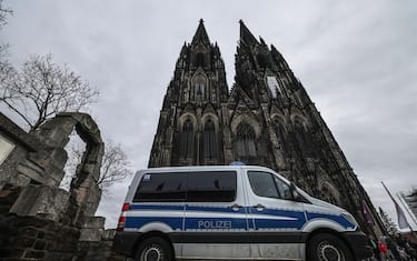 27 December 2023, North Rhine-Westphalia, Cologne: A police vehicle stands in front of the cathedral. Cologne Cathedral remains closed to visitors after the terror alert. Photo: Oliver Berg/dpa (Photo by Oliver Berg/picture alliance via Getty Images)