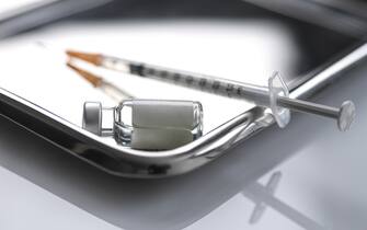 Syringe and vial on metal tray