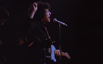 American musician and lyric poet, playing his guitar, 1965