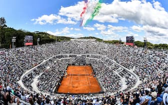1144030789 TOPSHOT - The Frecce Tricolori air squadron flies over the Foro Italico as Serbia's Novak Djokovic plays against Canada's Denis Shapovalov during their ATP Masters tournament tennis match in Rome on May 16, 2019. (Photo by Andreas SOLARO / AFP) (Photo credit should read ANDREAS SOLARO/AFP via Getty Images)