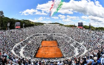 TOPSHOT - The Frecce Tricolori air squadron flies over the Foro Italico as Serbia's Novak Djokovic plays against Canada's Denis Shapovalov during their ATP Masters tournament tennis match in Rome on May 16, 2019. (Photo by Andreas SOLARO / AFP)        (Photo credit should read ANDREAS SOLARO/AFP via Getty Images)