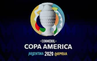 A screen displays the logo of the Copa America 2020 during the draw of the football tournament at the Convention Centre in Cartagena, Colombia, on December 3, 2019. - The Copa America 2020 football tournament will be held jointly by Argentina and Colombia next year from June 12 to July 12. Asian champions Qatar and previous winner Australia will participate as invited guest teams. (Photo by Juan BARRETO / AFP) (Photo by JUAN BARRETO/AFP via Getty Images)